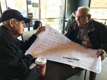 Bill Black and Stephen Emanuels peruse a map they used in their research for their book "A Lonesome Place to Live"